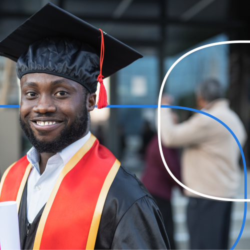 Smiling graduate in cap and gown at an outdoor graduation ceremony with peers in the background