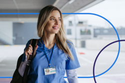 confident CRNA in scrubs walking with a bag, highlighting a typical day in the life of a certified registered nurse anesthetist