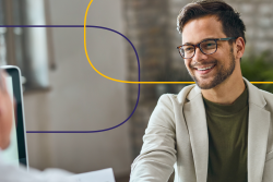 Smiling professional shaking hands during a physician recruiting interview, symbolizing successful healthcare hiring and active physician candidates.