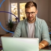 A physician working on a laptop from home, representing modern physician market trends and remote work in healthcare.