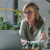 A female healthcare recruiter actively engages on a laptop in a contemporary office setting