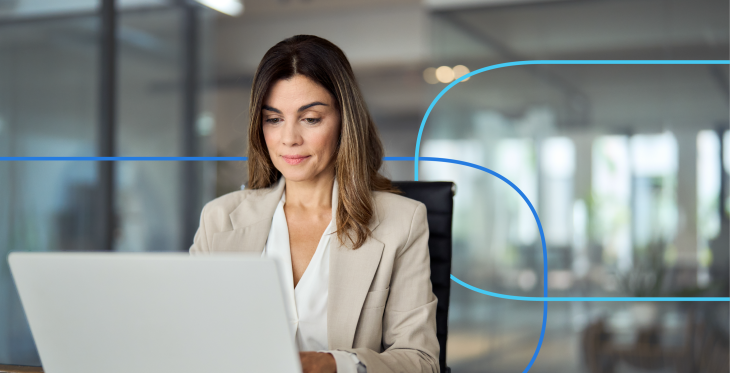 Professional woman in a business setting focused on her laptop, illustrating the process of learning how to write a medical CV