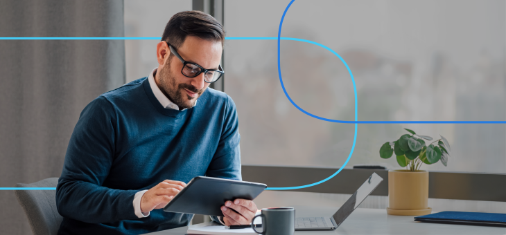 Professional man using tablet for job search tips at modern office desk with laptop and coffee mug – career planning for healthcare job seekers