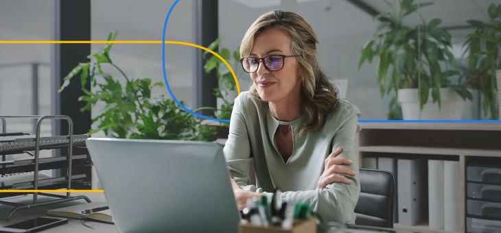 A female healthcare recruiter actively engages on a laptop in a contemporary office setting