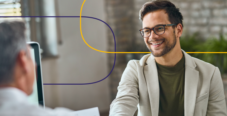 Smiling professional shaking hands during a physician recruiting interview, symbolizing successful healthcare hiring and active physician candidates.