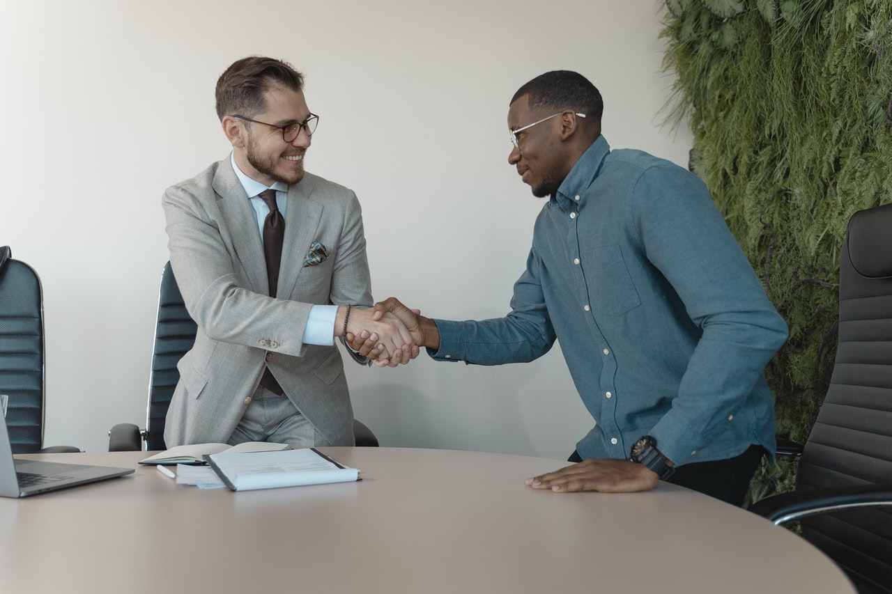 Two people shaking hands during a hiring process/job interview