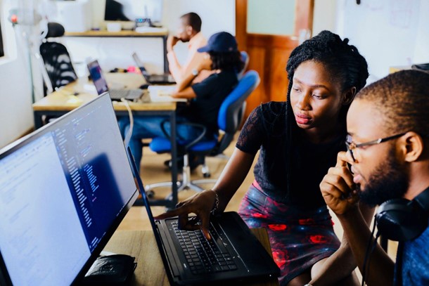 BIPOC employees working on a computer.