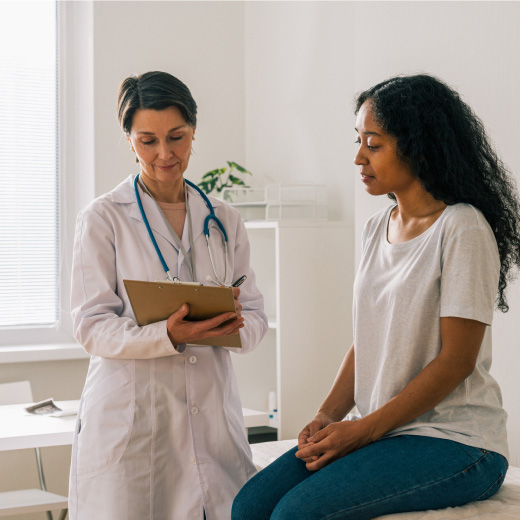 Doctor reading chart to patient